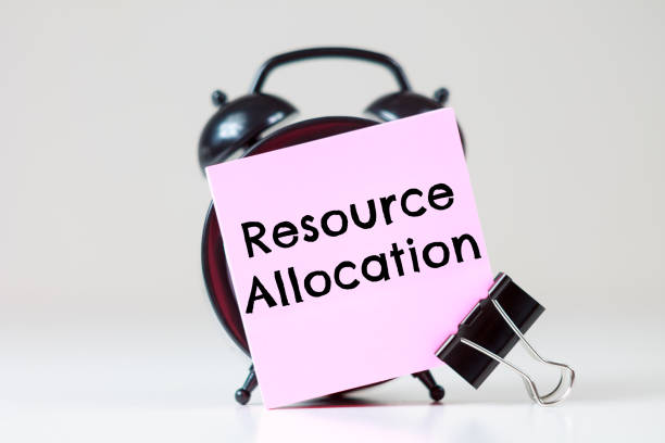 istock Resource Allocation text on a sticker for reminders with an alarm clock 2202218818