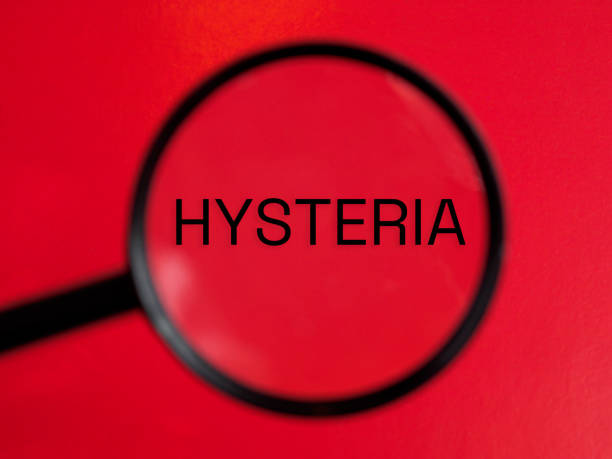 istock Hysteria text through magnifying glass red background 2202218925