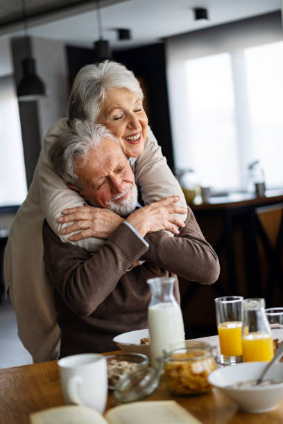 istock Beautiful senior couple having fun, smiling together while enjoying breakfast together 2202223431