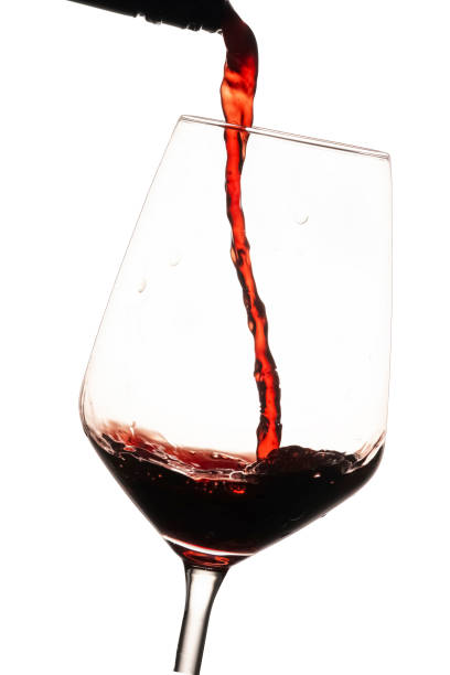 istock Red wine being poured in glass 2202225915
