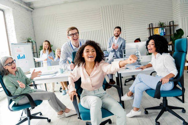 istock Diverse Business Team in Lively Interaction Celebrating Success in a Modern Office Environment 2202228239