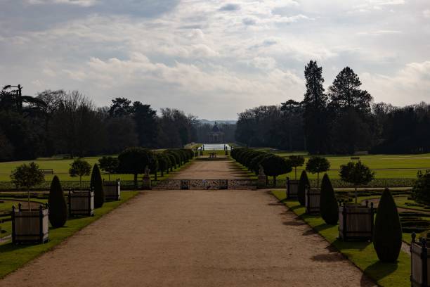 istock Serene garden pathway leading to distant pavilion. 2202234973