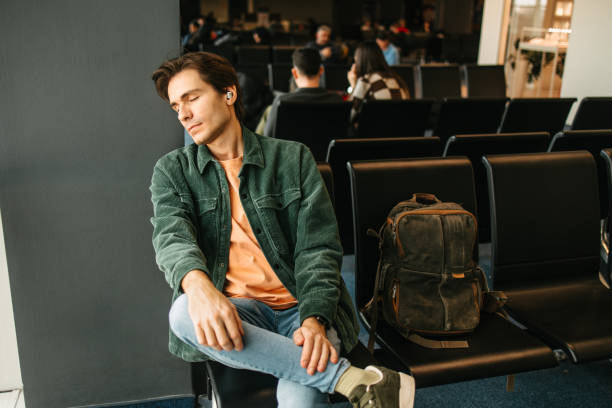 istock A man napping in the departure lounge 2202235320
