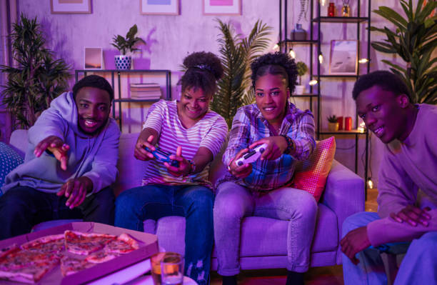 istock Excited friends playing video games at home 2202237498