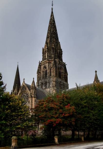 istock Historic church with tall spire and greenery. 2202237848