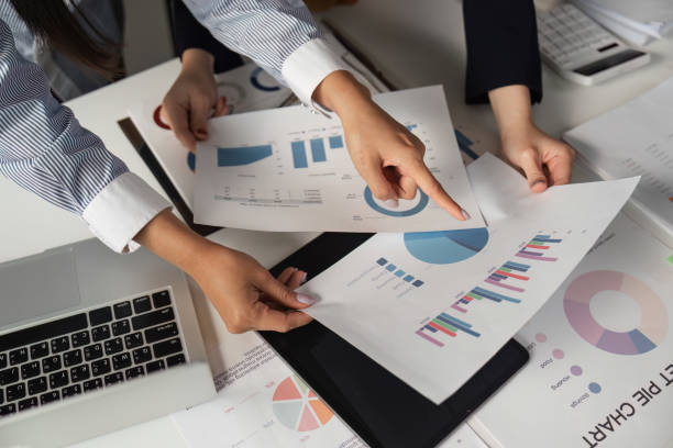 istock Diverse business team analyzing financial reports and charts during collaborative meeting at office table. 2202237957