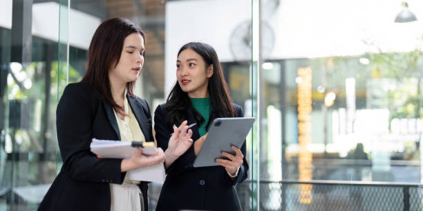 istock Two colleagues analyzing data and discussing strategies with a tablet in a bright office environment. 2202238049