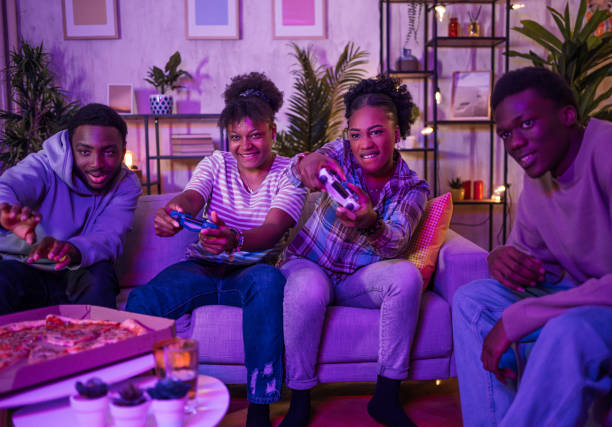 istock Excited friends playing video games at home 2202238772