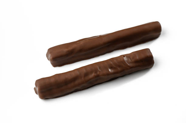 istock Delightful chocolate sticks arranged elegantly on a white background showcasing their smooth texture and rich color 2202238950