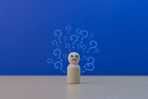 All round problems, Businessman wooden doll with question marks around him