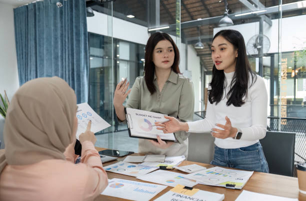 istock Dynamic discussion among office workers about financial strategies and project planning in a collaborative environment. 2202241043