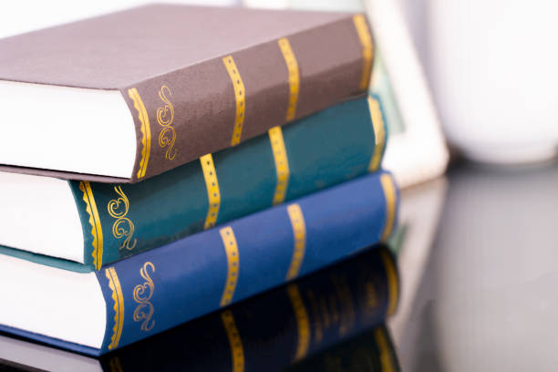 istock Stack of old books isolated on bokeh light background 2202241119