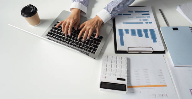 istock Financial professionals collaborating on tax reports and analysis in a modern office setting. 2202241271