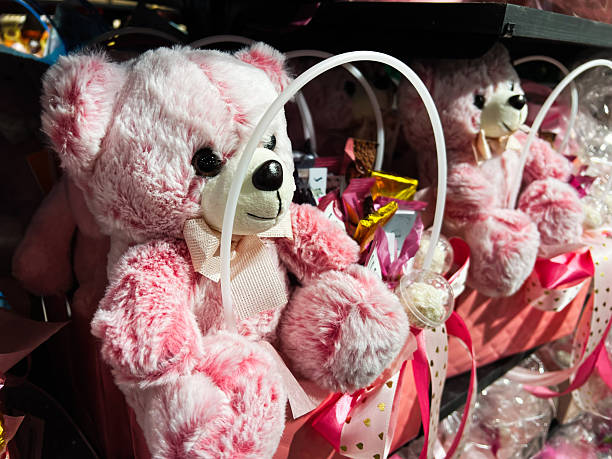 Pink stuffed teddy bears with gift baskets arranged on display
