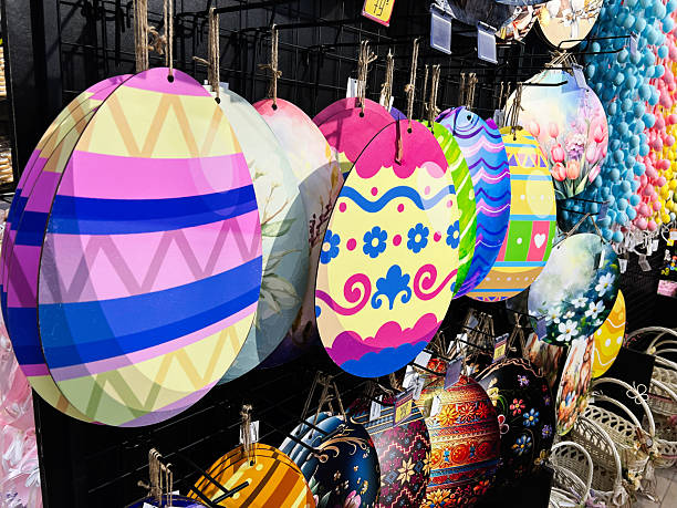 A selection of vibrant hand painted Easter egg ornaments hanging on display