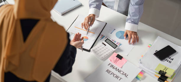 istock Diverse female finance professionals discussing financial reports in an office setting. 2202241732