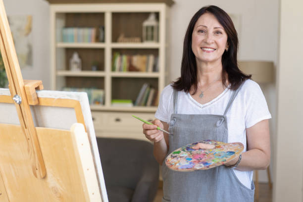 istock Focused woman using laptop for creative work in cozy space 2202241764