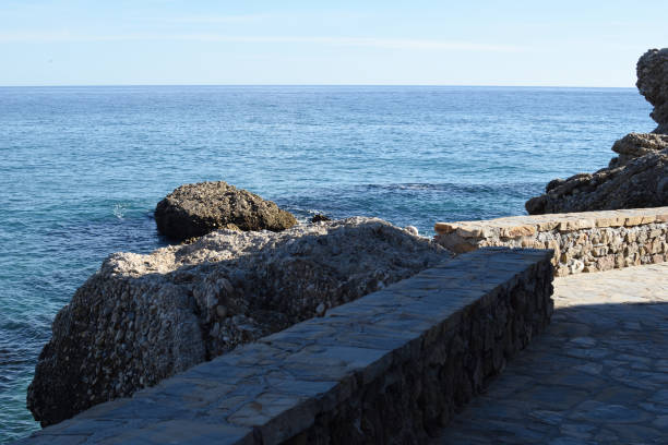 Stone Walkway by the Sea with Rocky Shoreline