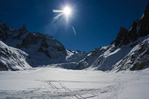 Punta Helbroner, Courmayeur, Italy - 15 March 2023: Skiers descending Punta Helbroner (3462) off the marked piste at the foot of Europe's highest mountain, Mount Blanc