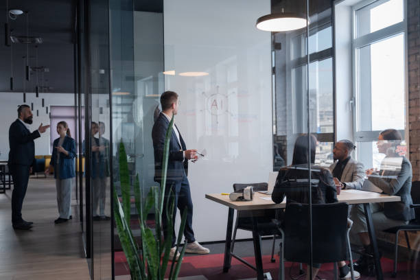 istock Modern office meeting with diverse professionals discussing artificial intelligence strategy. Concept of teamwork, technology, and corporate innovation in a contemporary workspace 2202248566