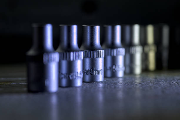 Socket wrench heads standing in a row on a dark surface. They made of chrome vanadium.