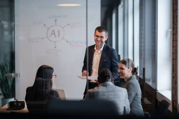 istock Diverse business team in a modern office during a meeting, discussing artificial intelligence strategy. Concept of AI innovation, teamwork, leadership, corporate planning, professional collaboration 2202252667