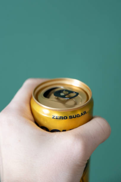 hand holding a zero sugar soda can. close up of hand holding a zero sugar soda can. coke zero photos stock pictures, royalty-free photos & images