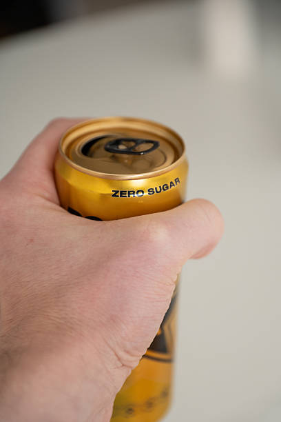hand holding a zero sugar soda can. close up of hand holding a zero sugar soda can. coke zero photos stock pictures, royalty-free photos & images