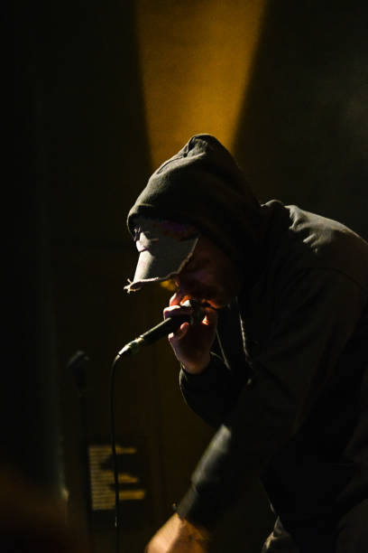 istock Mysterious Rap or Rock Singer Under Dark Stage Lights – Vertical Shot 2202255626