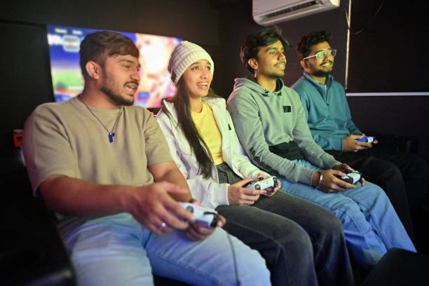 istock Group of young gamers holding controllers, playing video games at a gaming parlor 2202256041