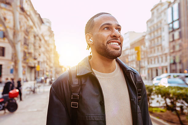 istock Young tourist exploring city street using wireless earbuds 2202256441