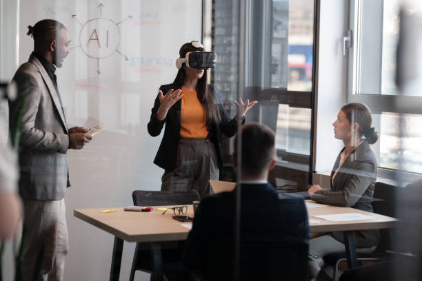 Business professionals in a modern office discussing artificial intelligence. A woman wearing a VR headset presents ideas while colleagues listen. Concept of AI technology in corporate meetings