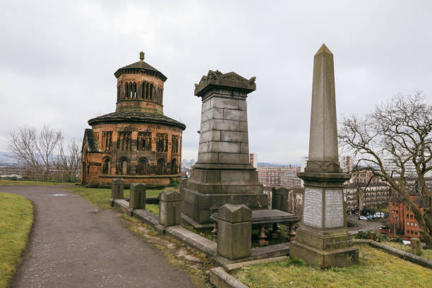 Glasgow, United Kingdom - November 12, 2024: Explore the stunning Glasgow Necropolis featuring impressive monuments and a gorgeous view overlooking the city on a cloudy day.