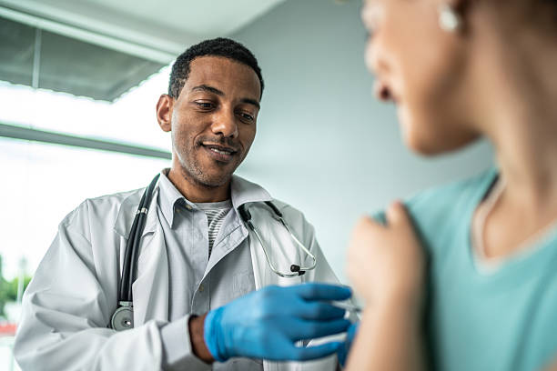 Doctor vaccinating a young woman