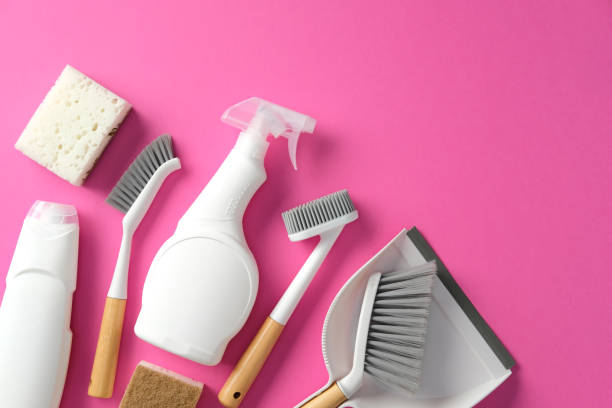 istock Eco-friendly cleaning supplies on a pink background, featuring brushes, sponges, spray bottle, and detergent. Perfect for sustainable household cleaning themes. 2202260871