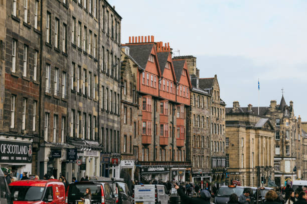 Edinburgh, United Kingdom - November 10, 2024: Visitors stroll along the bustling streets of Edinburgh, admiring historic buildings and enjoying the lively atmosphere.