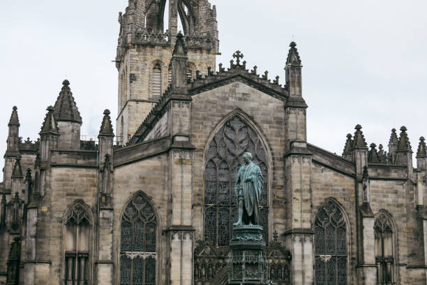 istock Historical cathedral in Edinburgh with a statue in the foreground on a cloudy day 2202262962