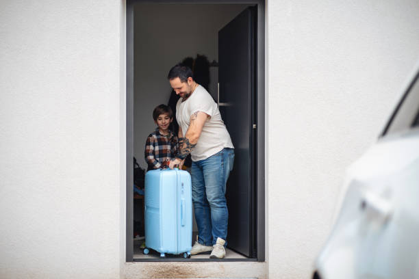 istock Father and Son Packing for Vacation 2202265502