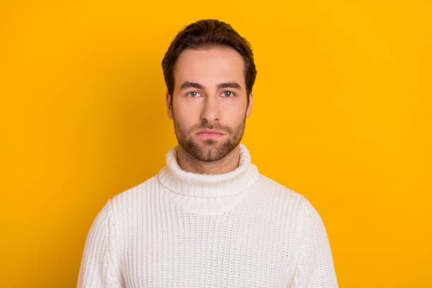 istock Photo of calm focused concentrated guy look camera wear white knitted pullover isolated yellow color background 2202271788