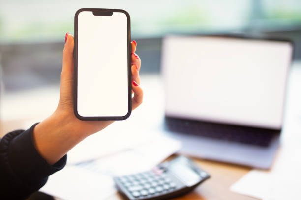 istock Closeup businesswoman using smartphone at office desk. 2202271853