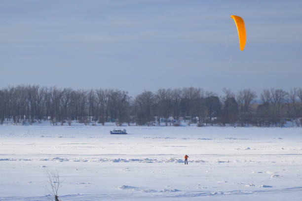 Samara, Russia - February 12, 2025: Snowkiting kitesurfing on the ice of a frozen river.