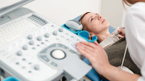istock A doctor in blue gloves performs a thyroid ultrasound 2202276290