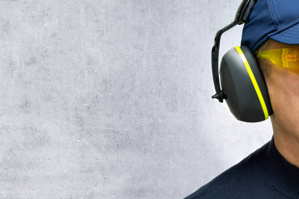 Worker in hearing protection device. Noise protection.
