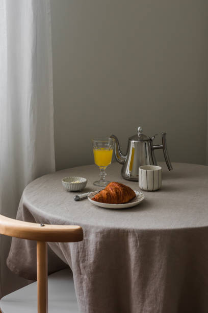 istock A simple mediterranean style breakfast - espresso, croissant, butter, orange juice on a round table with a gray tablecloth 2202280310