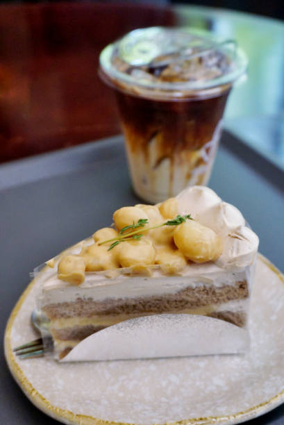 A piece of pasta frola with coffee on a wooden table.