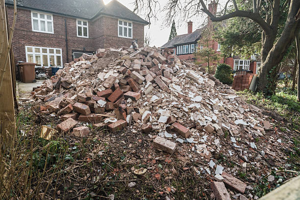 Heap of weathered bricks at house demolition site, construction waste concept. Selective focus.