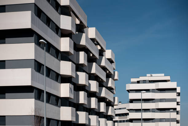 istock Modern suburb architectural buildings with unique design against clear blue sky in urban setting 2202284904
