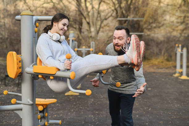 Male Fitness Instructor Shouting Motivating Female While Doing Abdominal Exercises