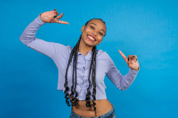istock Young woman pointing and smiling on blue background 2202288208