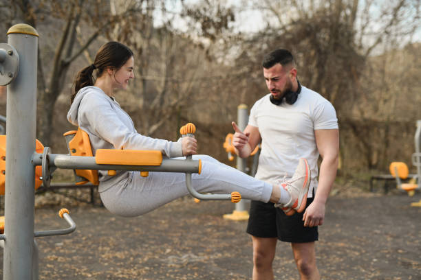 Female Struggling During Intensive Abs Workout While Male Coach is Counting Her Reps